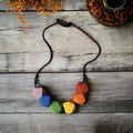 Precious Days Gifts rainbow silicone teething necklace with geometric beads for babies.