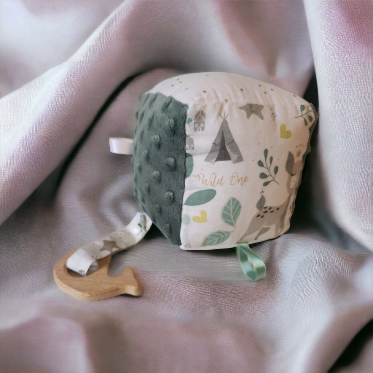 Precious Days Gifts soft sensory activity cube with woodland print, green minky fabric, and wooden teething ring.