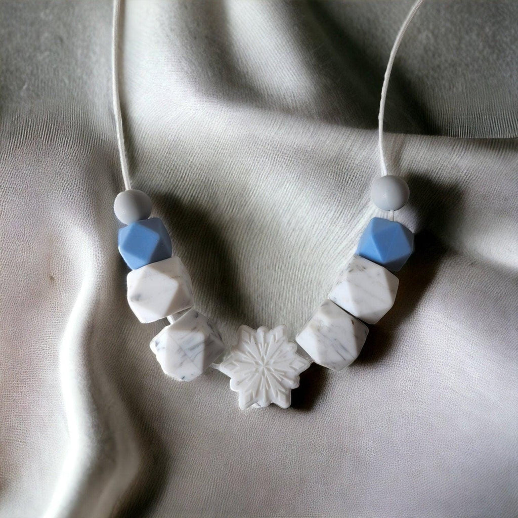 Precious Days Gifts handmade silicone teething necklace with blue, white marble, and grey beads, featuring a snowflake pendant.