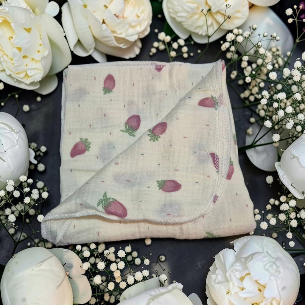 Precious Days Gifts cotton muslin cloth with pink strawberry print, surrounded by white peonies and baby's breath.