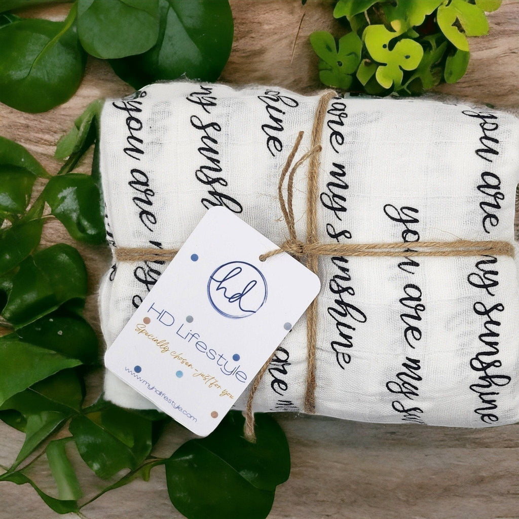 Precious Days Gifts large white cotton muslin with black 'you are my sunshine' print, tied with twine.