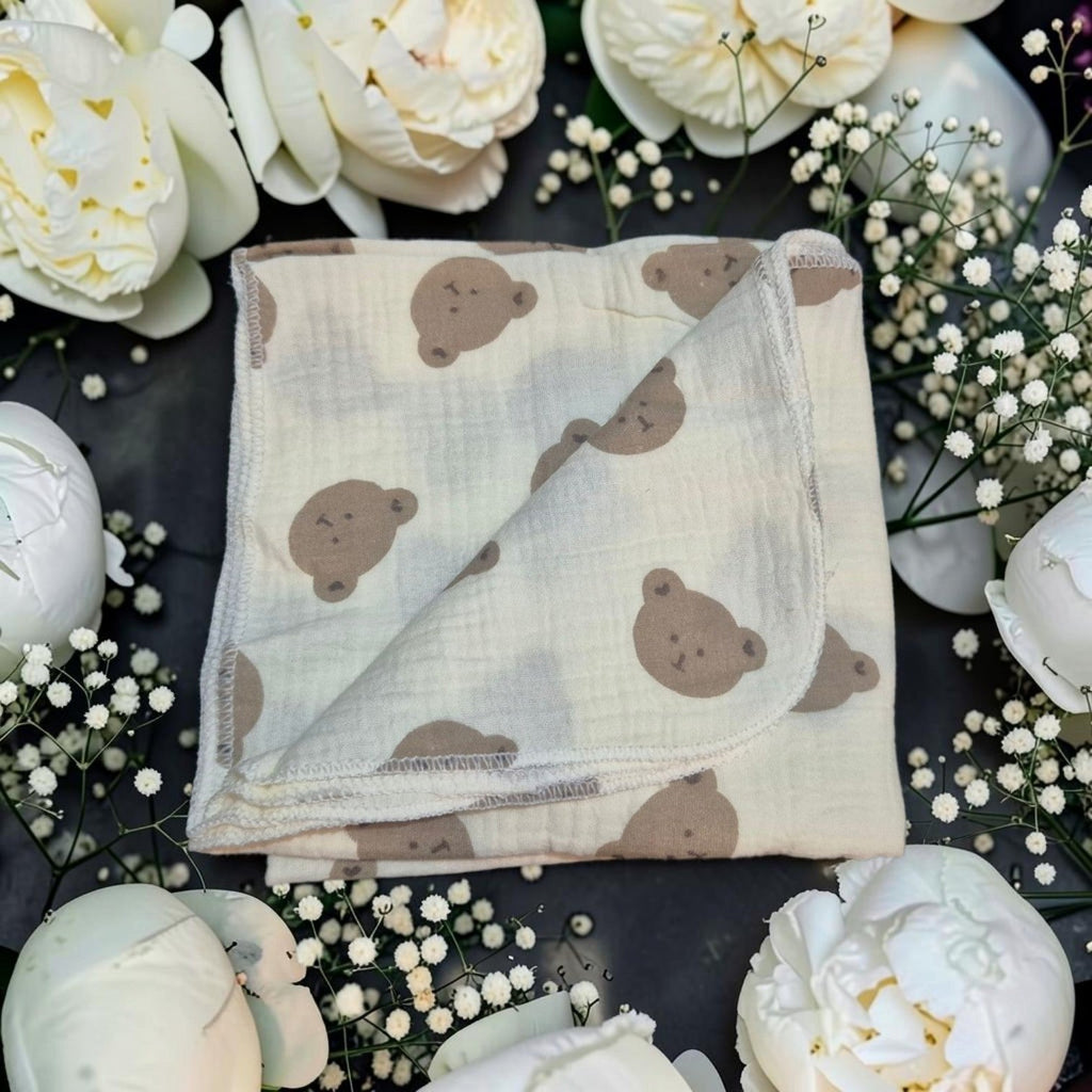 Precious Days Gifts muslin cloth with brown teddy bear print on cream cotton, surrounded by white flowers.