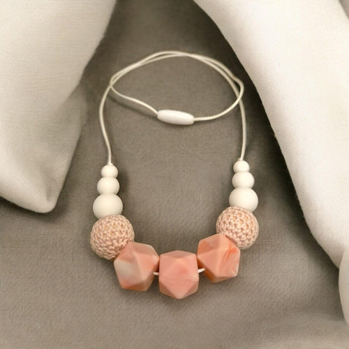 Precious Days Gifts handmade teething necklace with white, pink, and textured beads. BPA-free silicone.