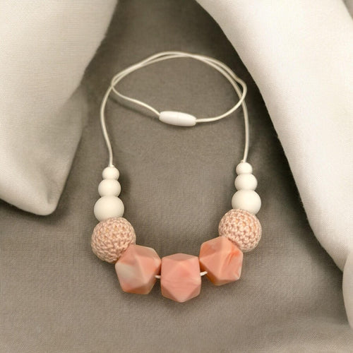 Precious Days Gifts handmade teething necklace with white, pink, and textured beads. BPA-free silicone.