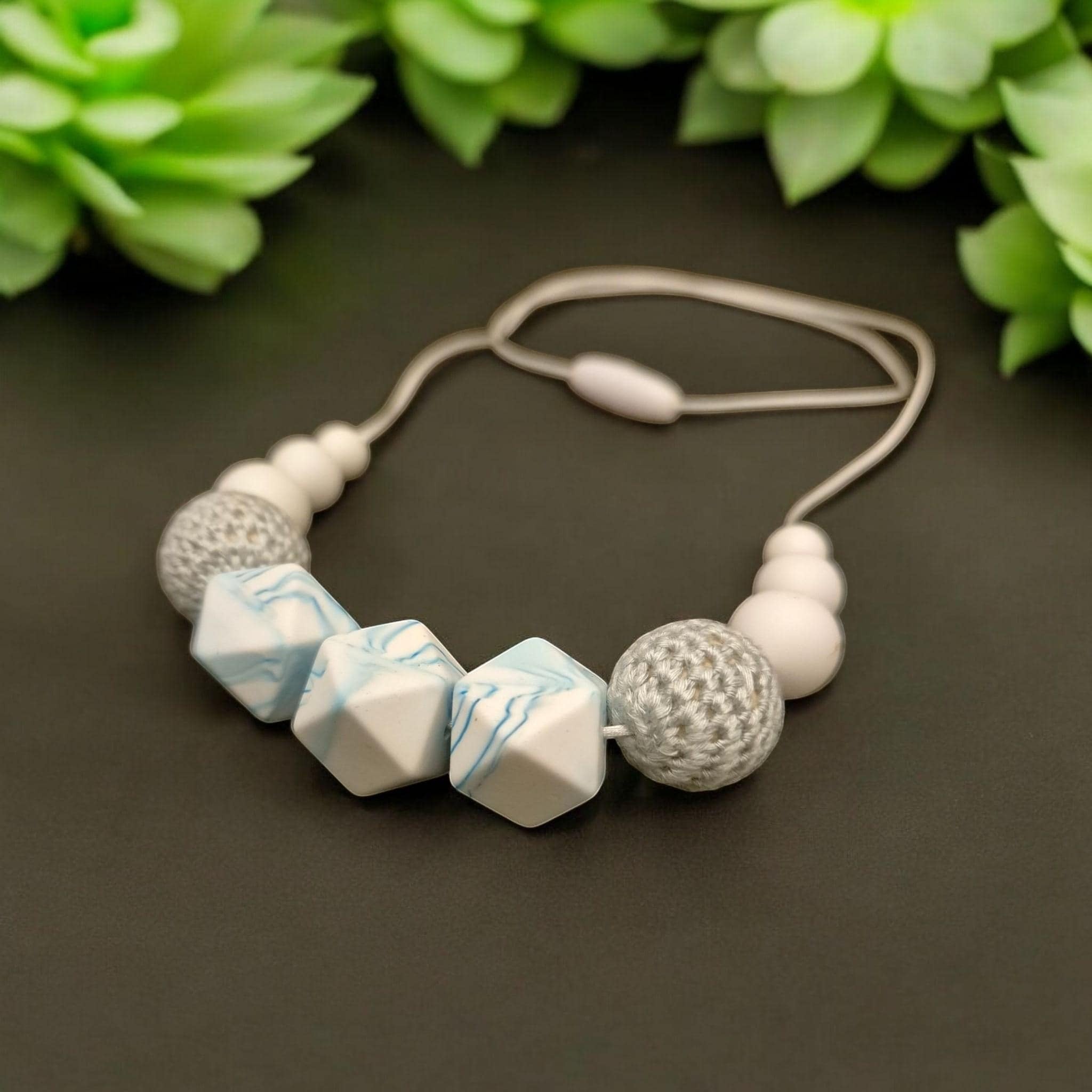 Precious Days Gifts handmade teething necklace with white, blue marble, and grey crochet silicone beads. Features a break-away clasp.