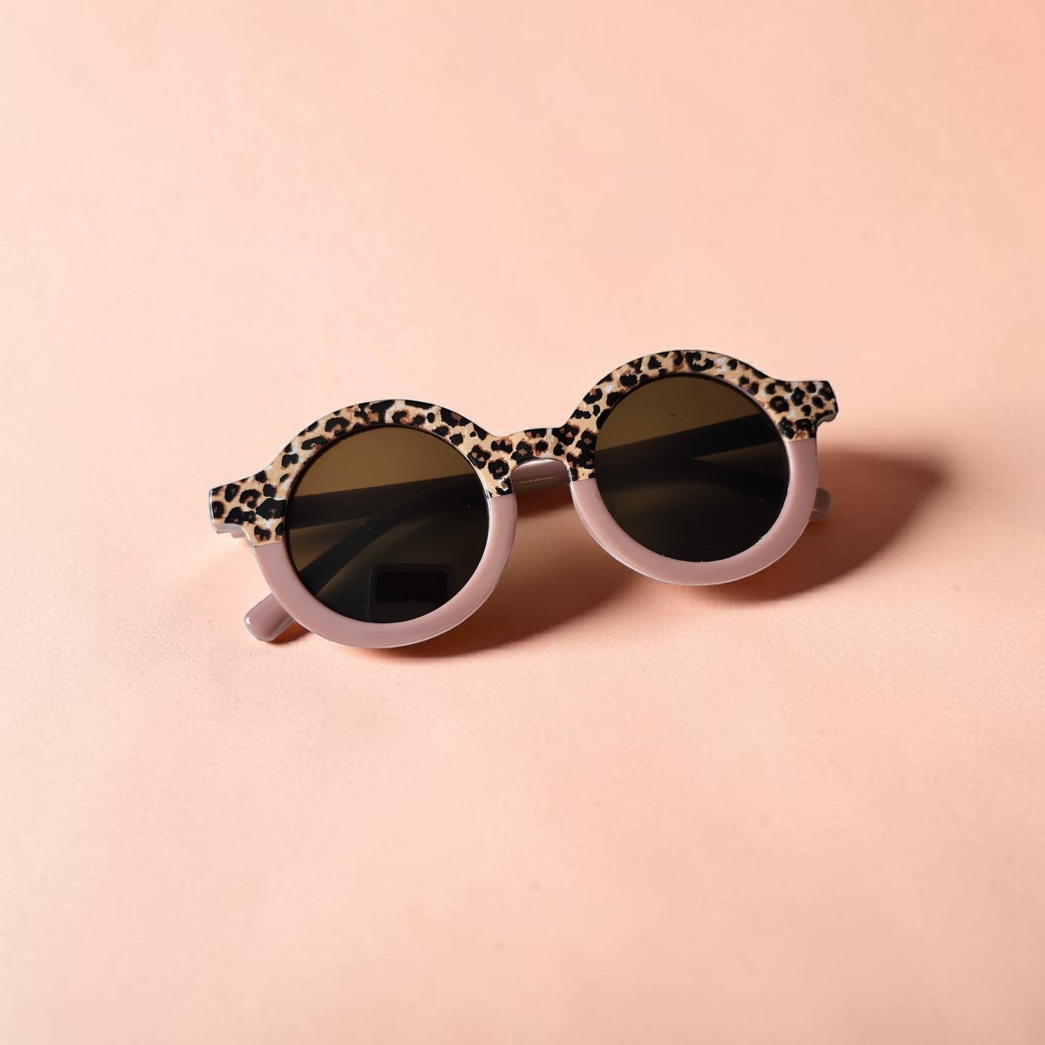 Precious Days Gifts toddler sunglasses with round lenses and leopard print frames.
