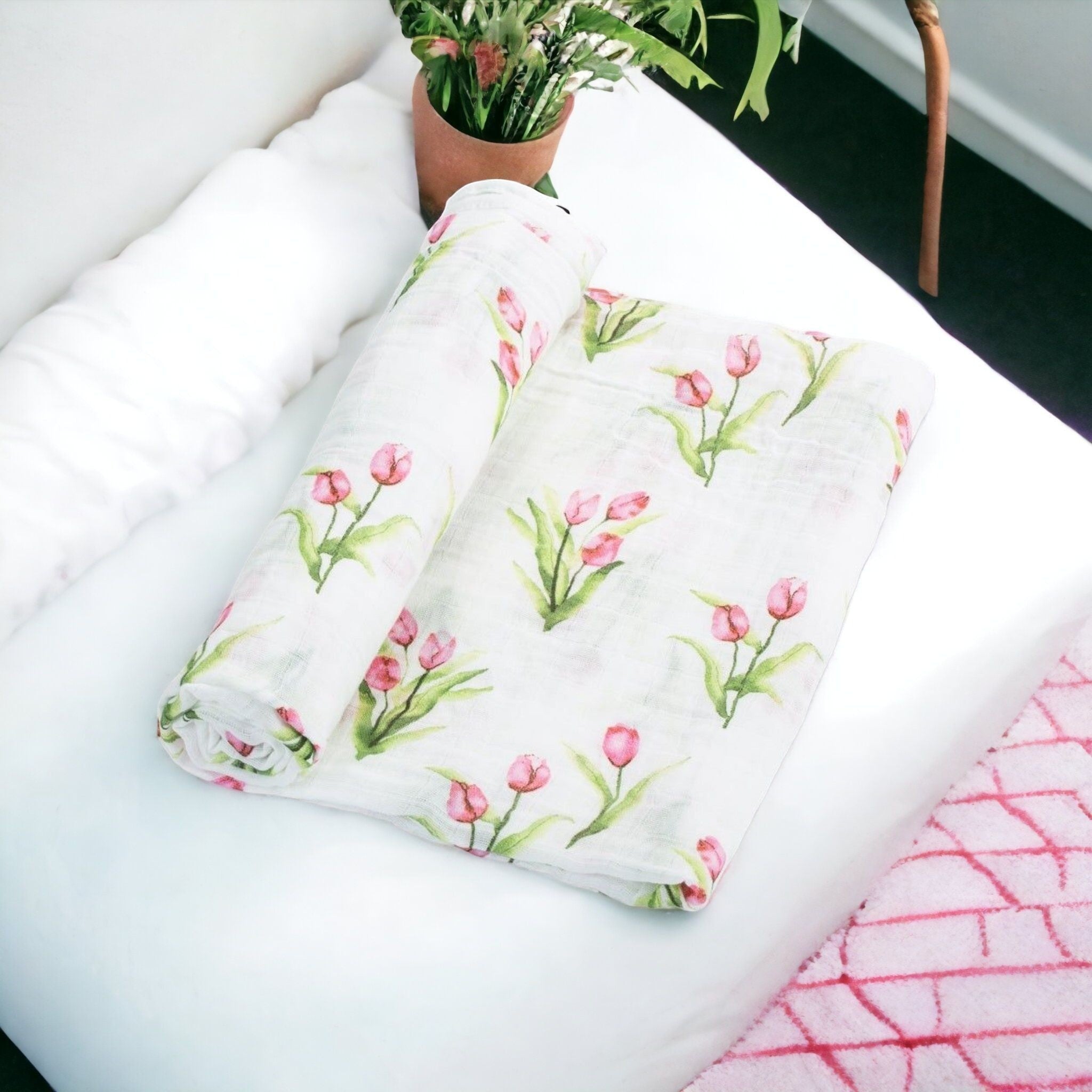 Precious Days Gifts 100% cotton muslin baby swaddle blanket featuring a pink tulip garden print on white fabric.