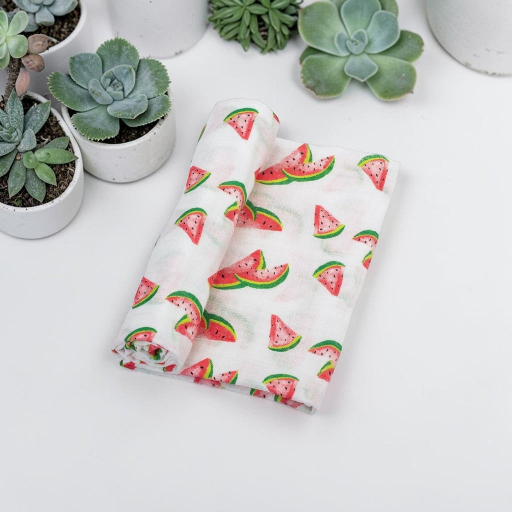 Precious Days Gifts 100% cotton muslin swaddle blanket with a cute watermelon print on a white background.