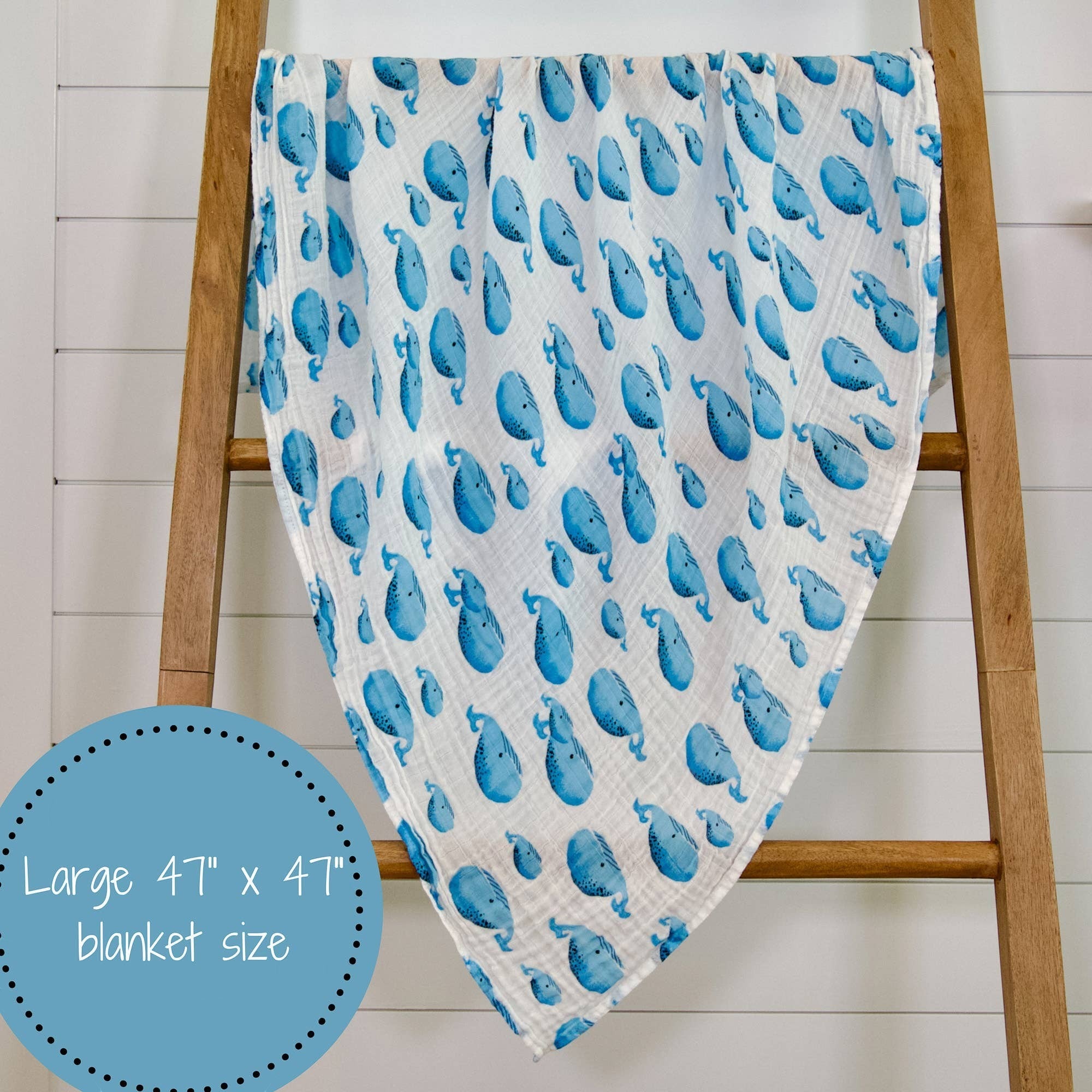 Precious Days Gifts white 100% cotton muslin swaddle blanket with a blue whale print. Large 120x120cm size.