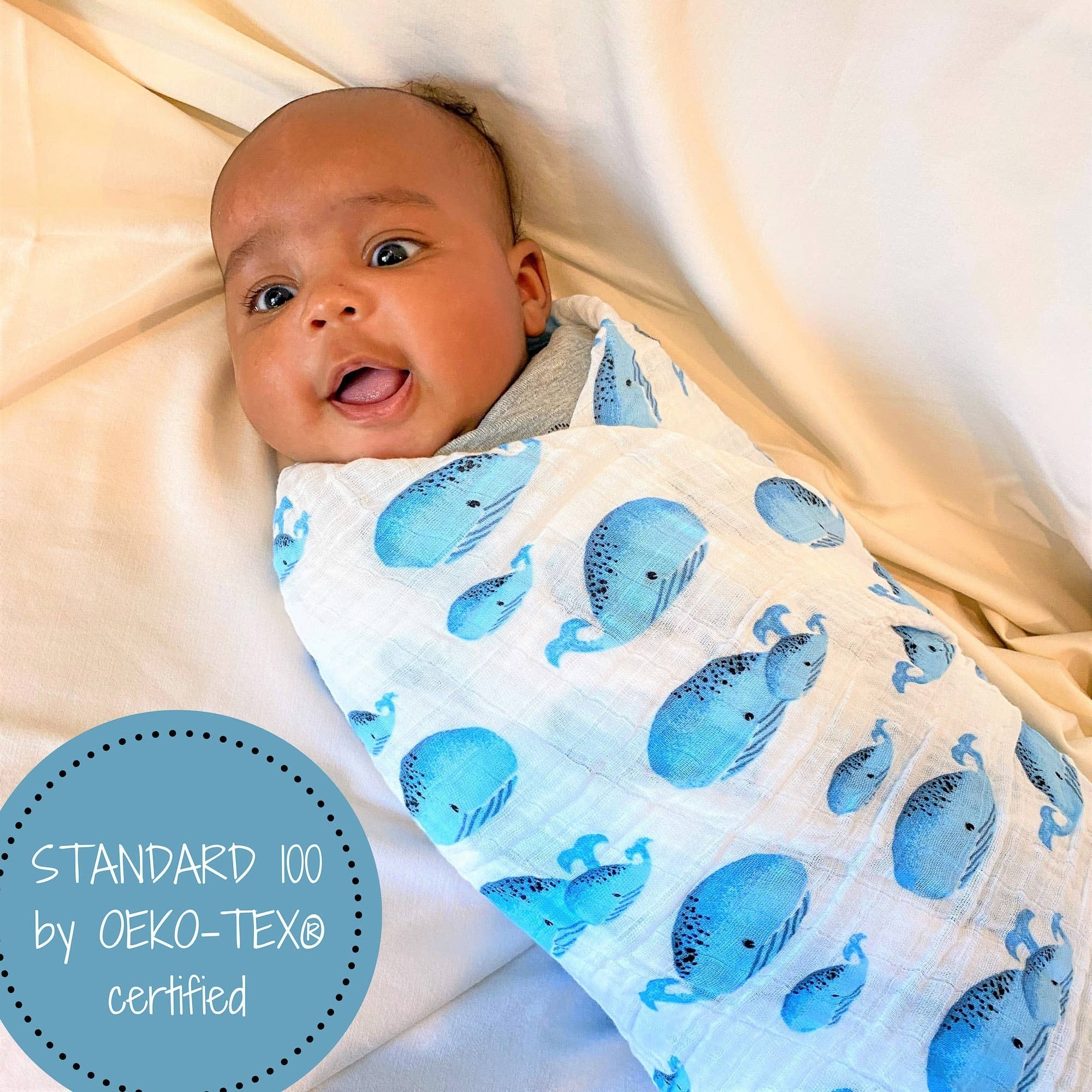 Precious Days Gifts baby swaddle blanket with blue whale print, 100% cotton muslin, OEKO-TEX certified.